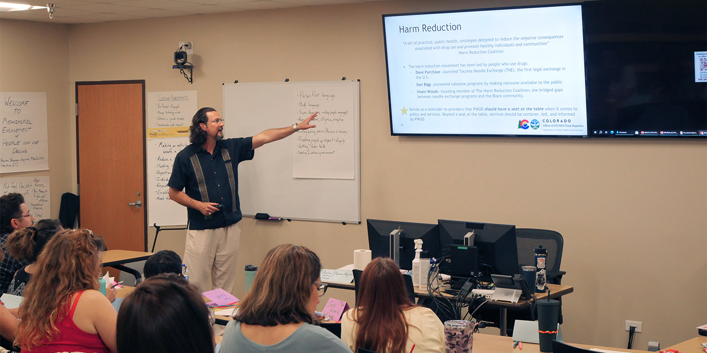 STI employee conducts training on harm reduction