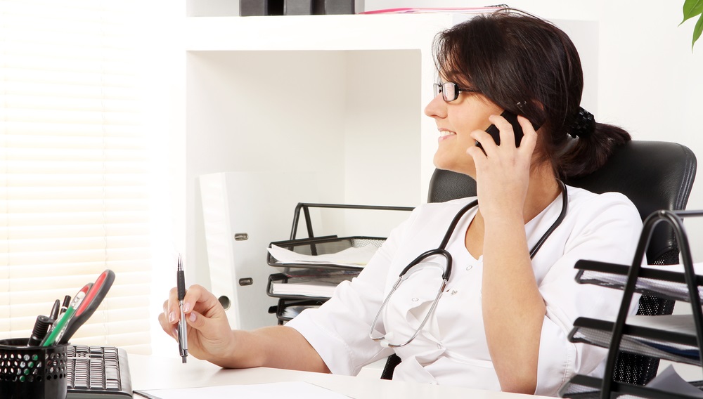 medical professional on phone in office