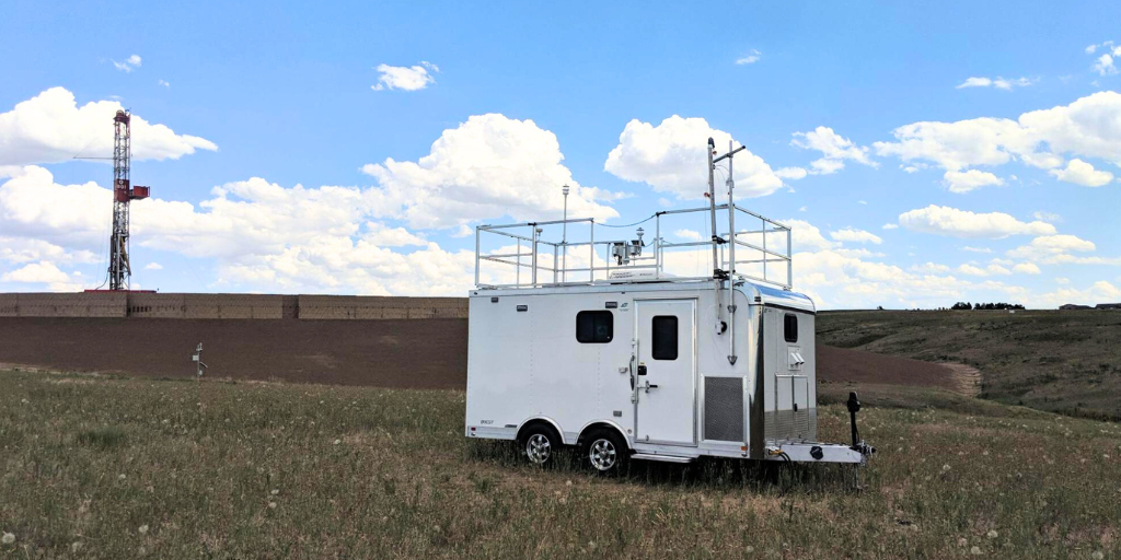 Colorado Air Monitoring Mobile Lab trailer parked in rural Colorado with sampling intakes visible on the roof.