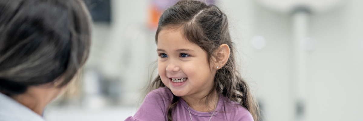 A young girl gets a checkup in a doctor's office.