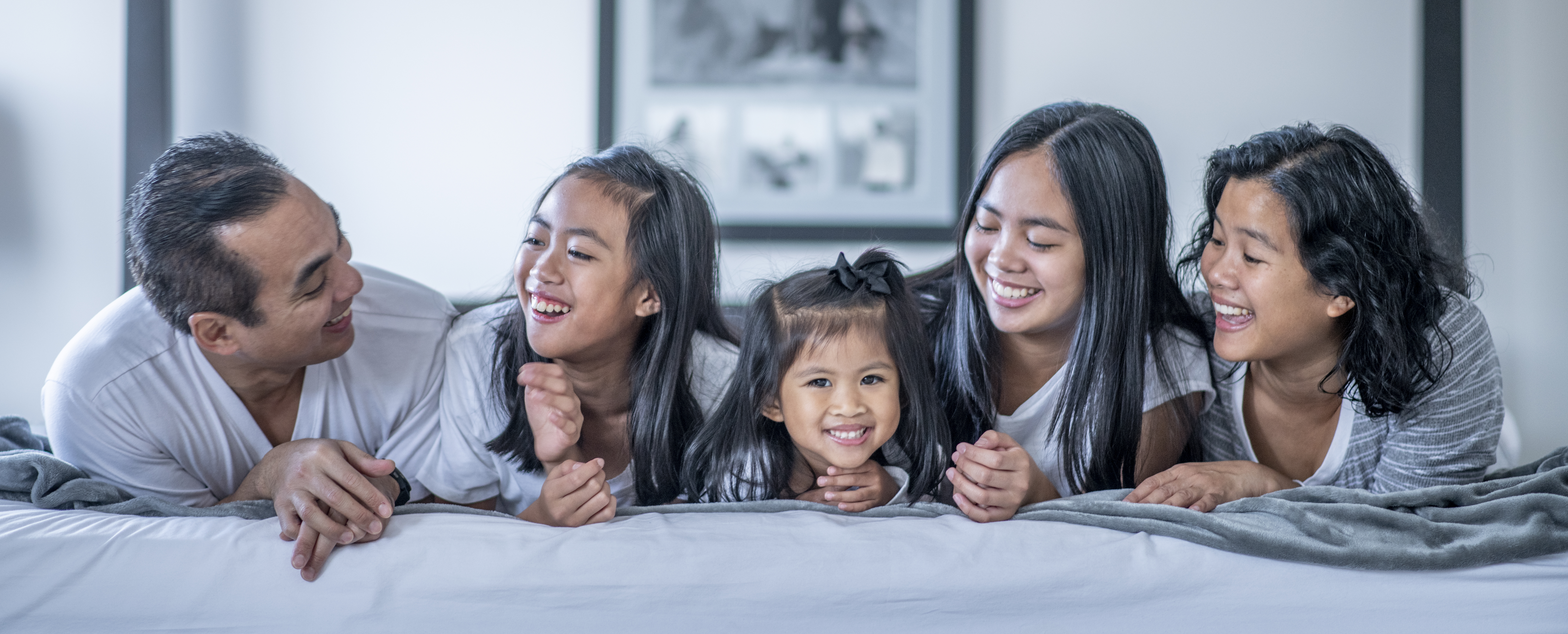 Kids crashing their parents bed.