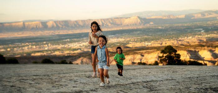 Children running on a Colorado mesa