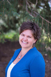 Caroline Mitchell, white female with brown hair and a blue blazer.