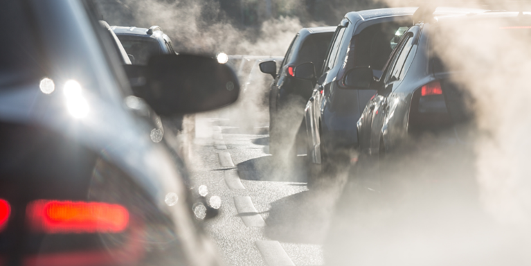 Bumper to bumper traffic, exhaust fills the air with smog