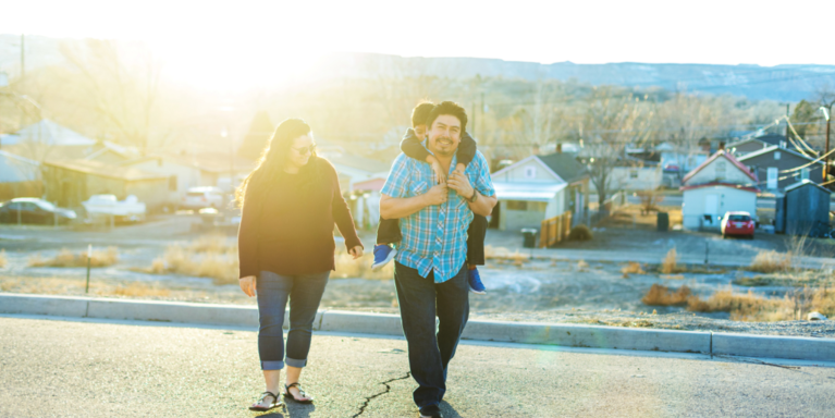 Latinx Family (mom, dad, child) spend time outside in Grand Junction